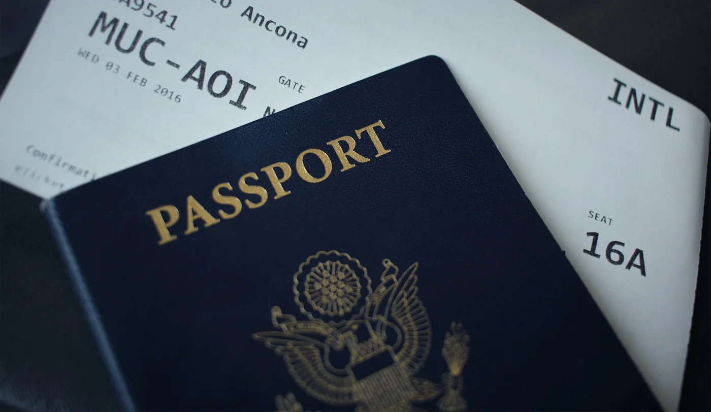 A United States passport resting on an airline boarding pass